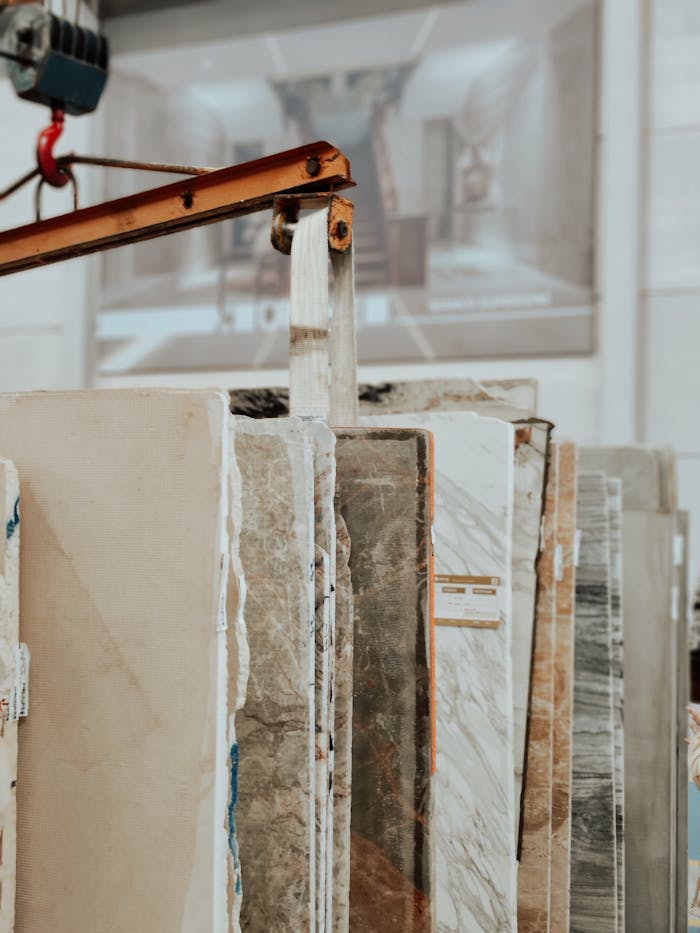 pexels-photo-19302430 Vertical shot of marble and granite slabs with a construction hook indoors.