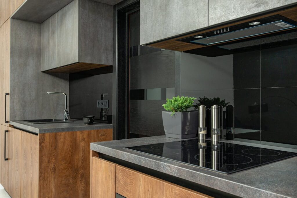 pexels-photo-7045351 Sleek modern kitchen with wood and stone elements, emphasizing a minimalist aesthetic.